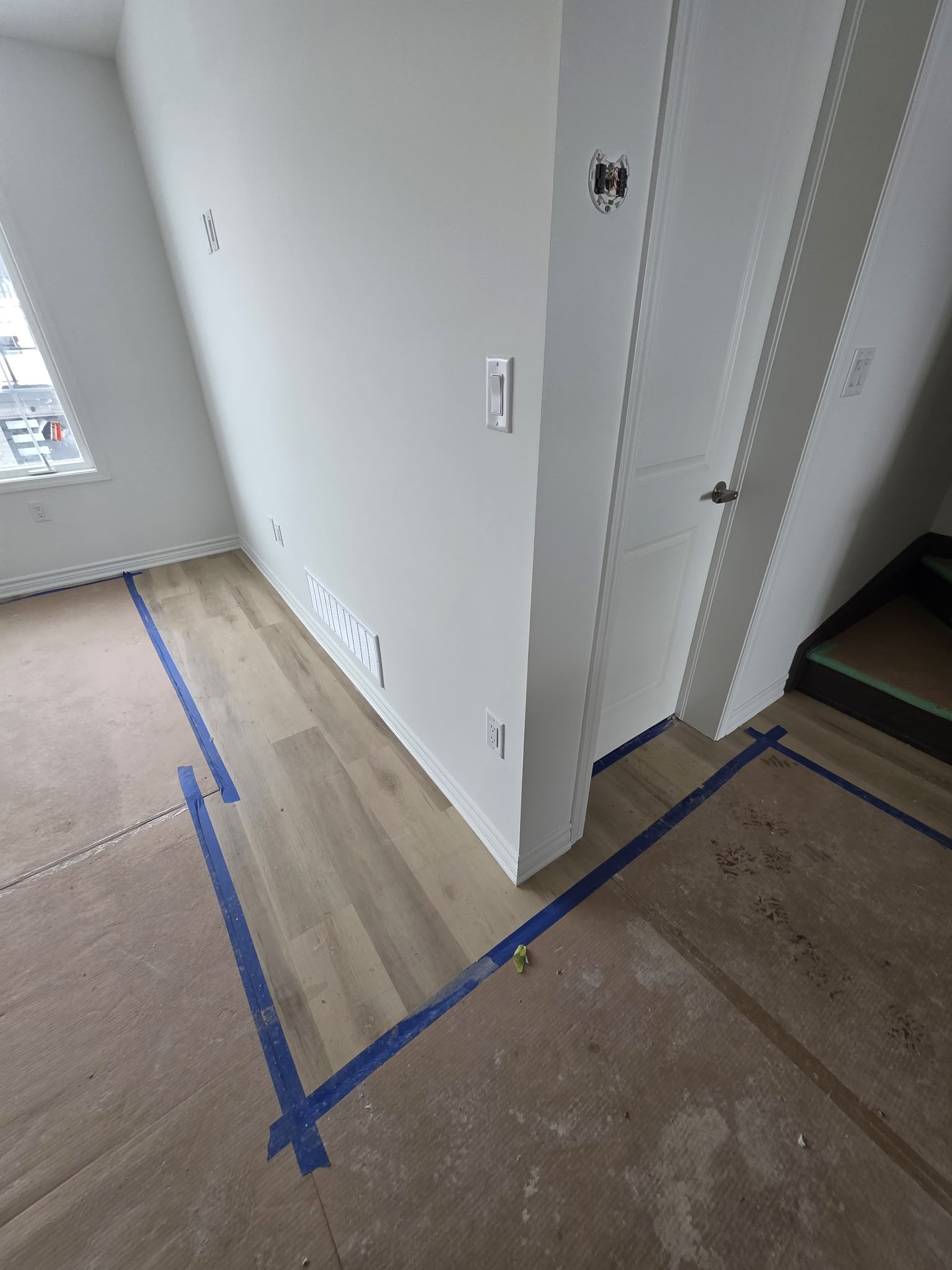 Fresh white baseboard installed through a hallway and doorway