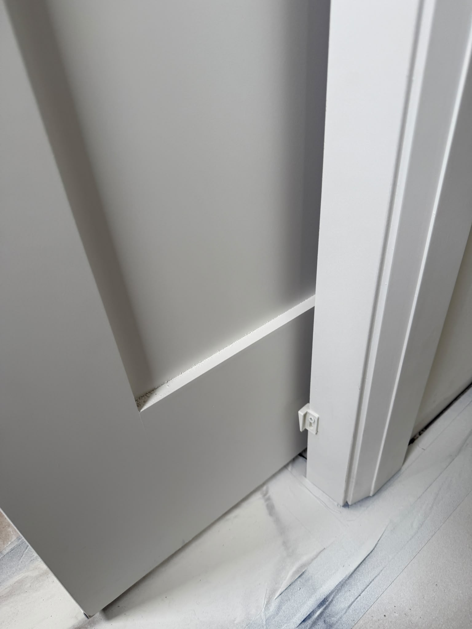Close-up of a neat trim transition beside a door frame