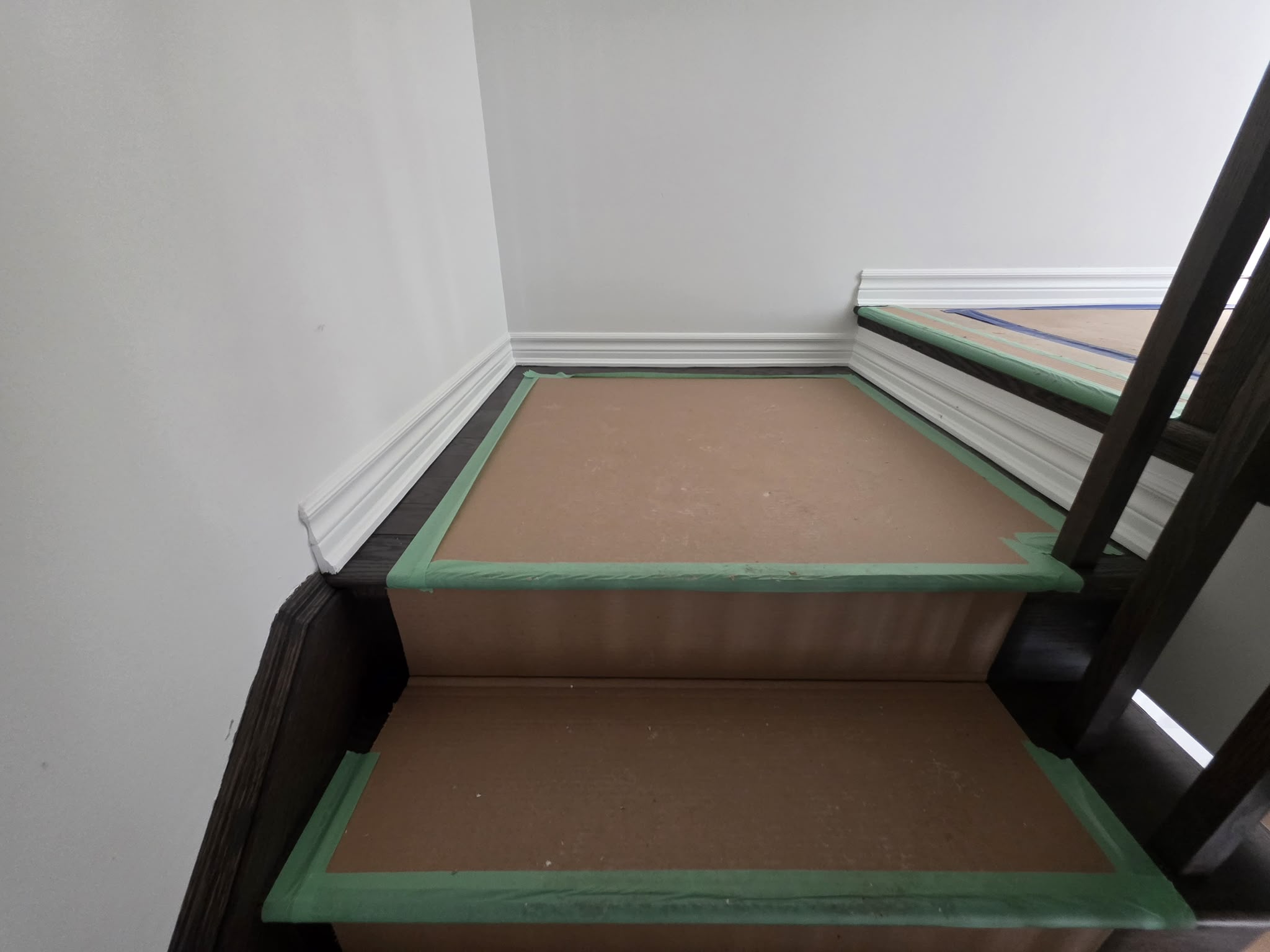 Close view of finished white trim along a staircase landing